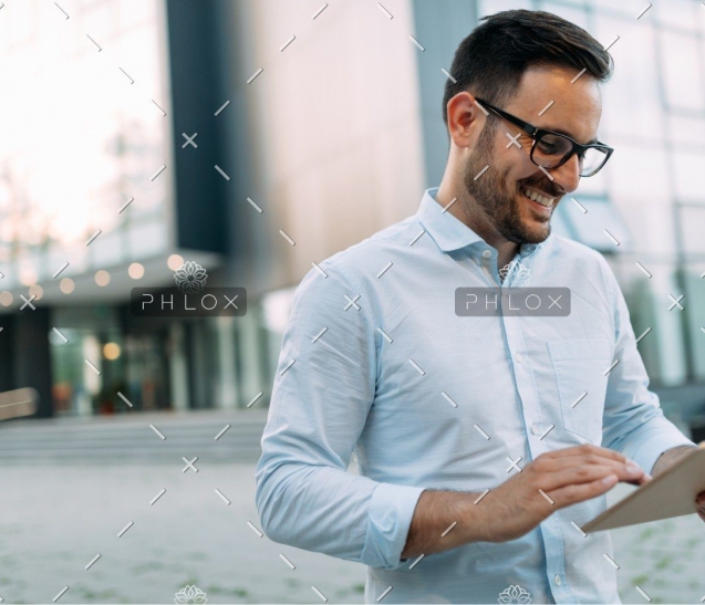 demo-attachment-336-portrait-of-businessman-in-glasses-holding-tablet-AWVHCJU